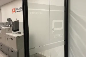 Photo of interior office signage and vinyl frosted glass.