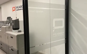 Photo of interior office signage and vinyl frosted glass.